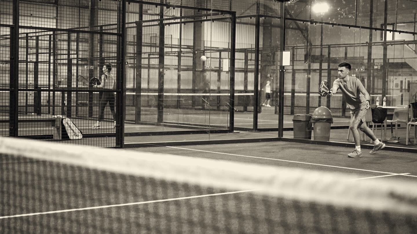 Padel court with glass walls and net