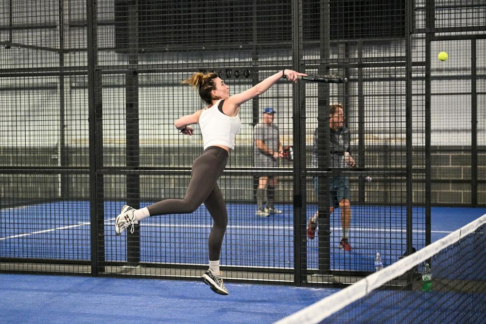 Player leaping at the net at Velocity Padel Widnes