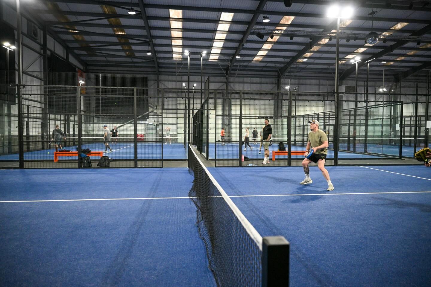 Indoor padel courts with steel frames, glass and LED floodlights